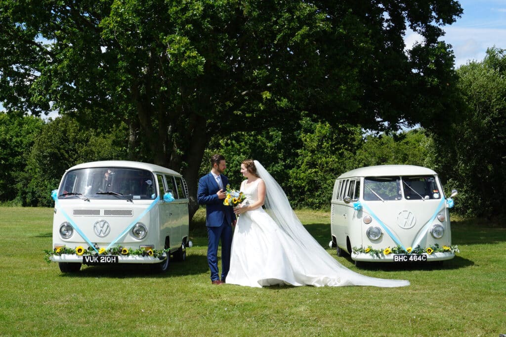Pair of classic wedding cars with bride and groom in Kent