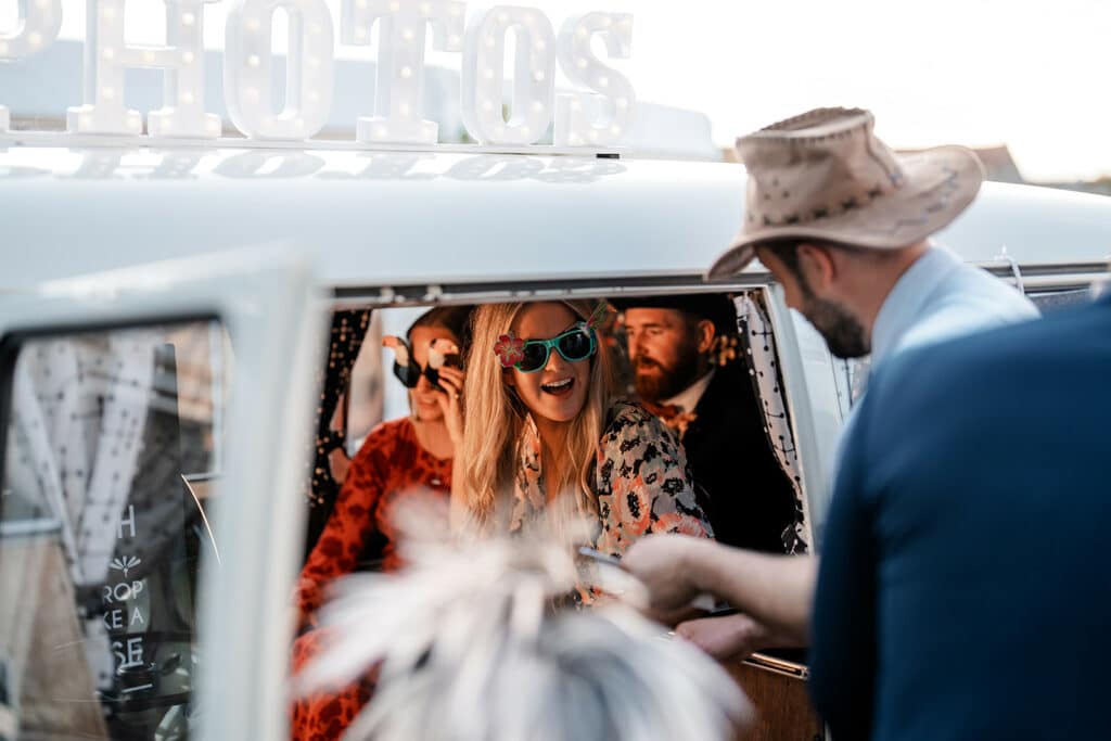 wedding guests inside the photo booth wearing sunglasses