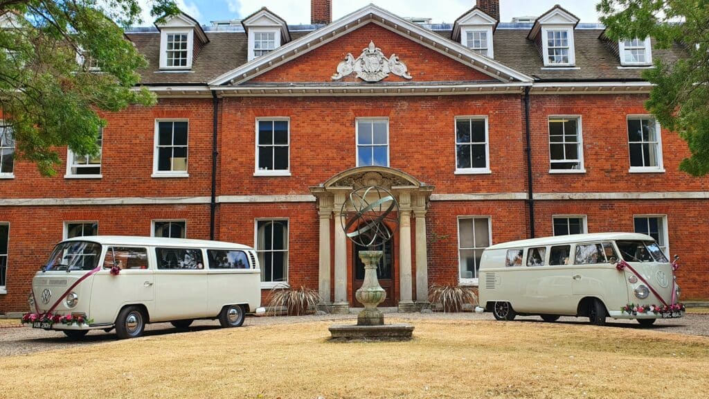 pair of classic white wedding cars