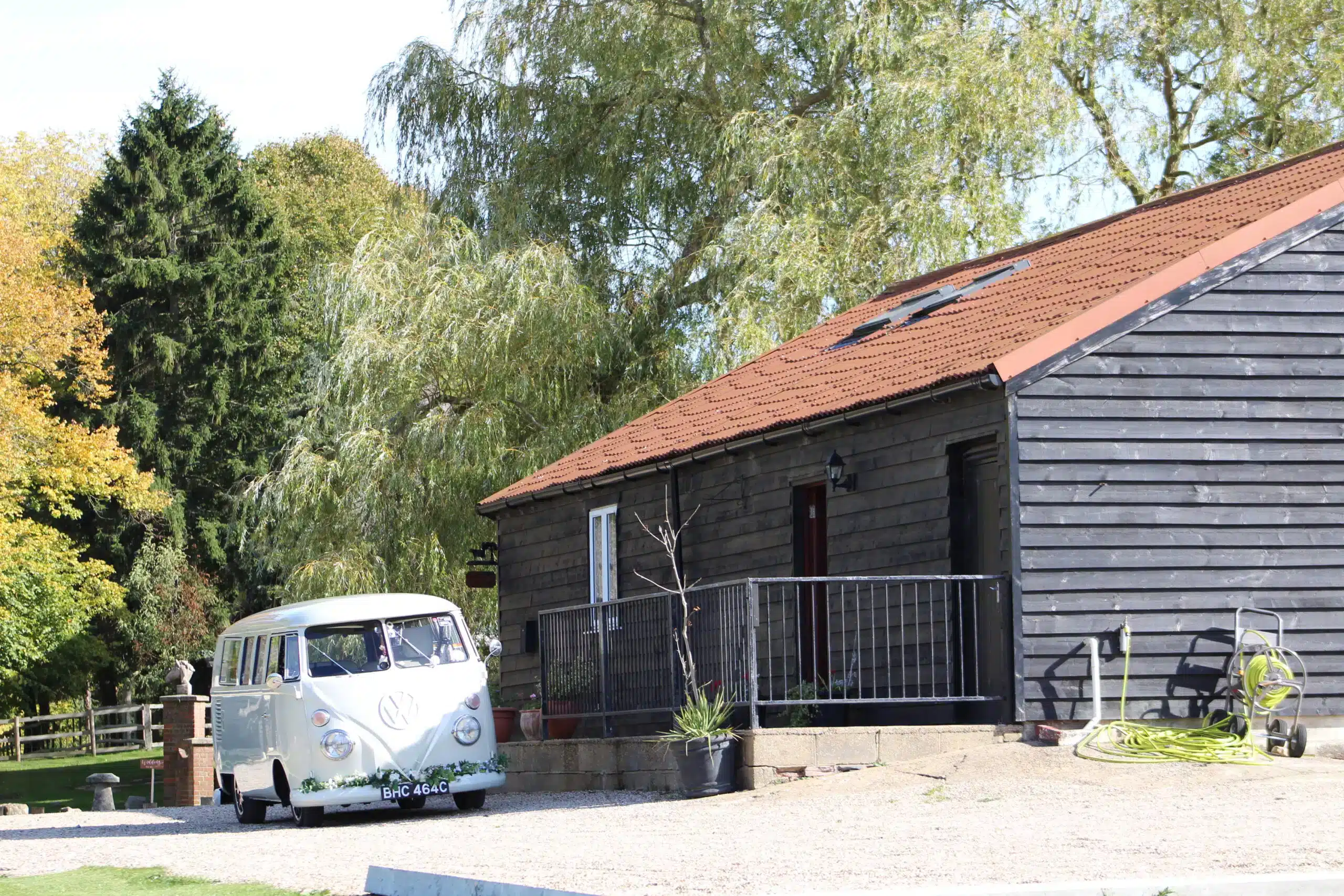 retro wedding van next to a barn wedding venue in Essex.