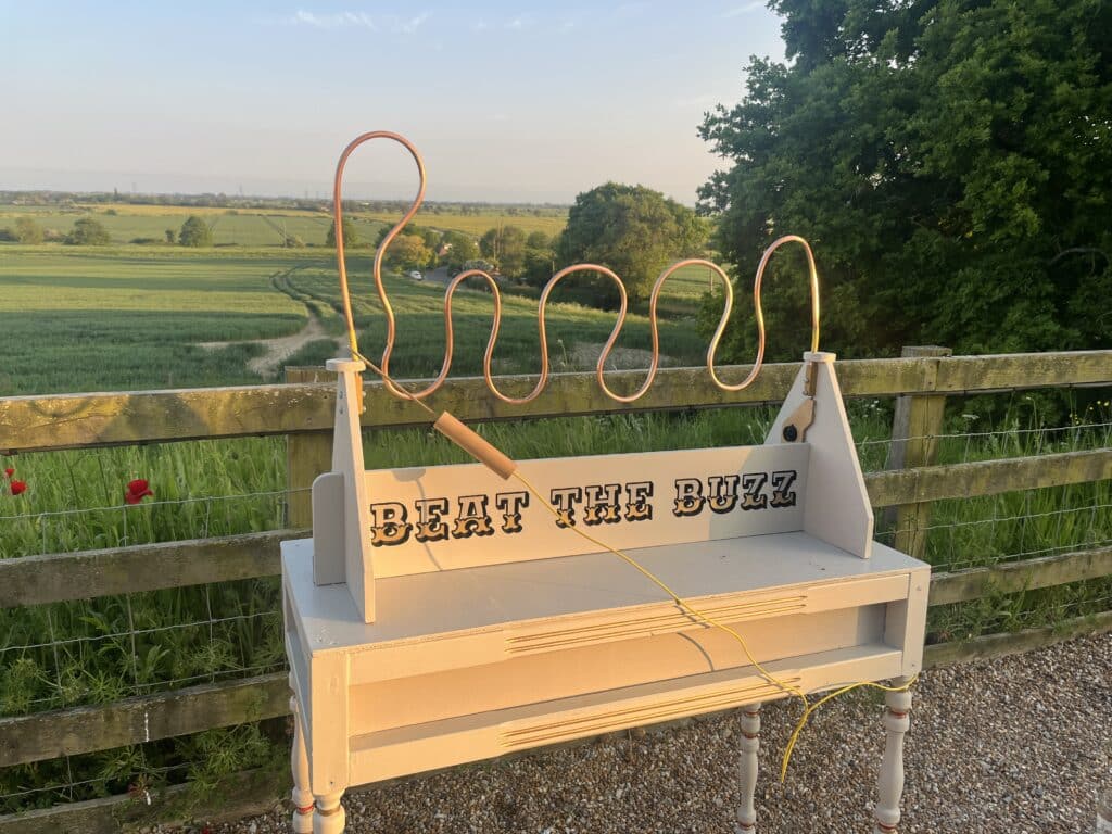 Beat the Buzz wedding game hire at a wedding – classic fairground wire loop challenge
