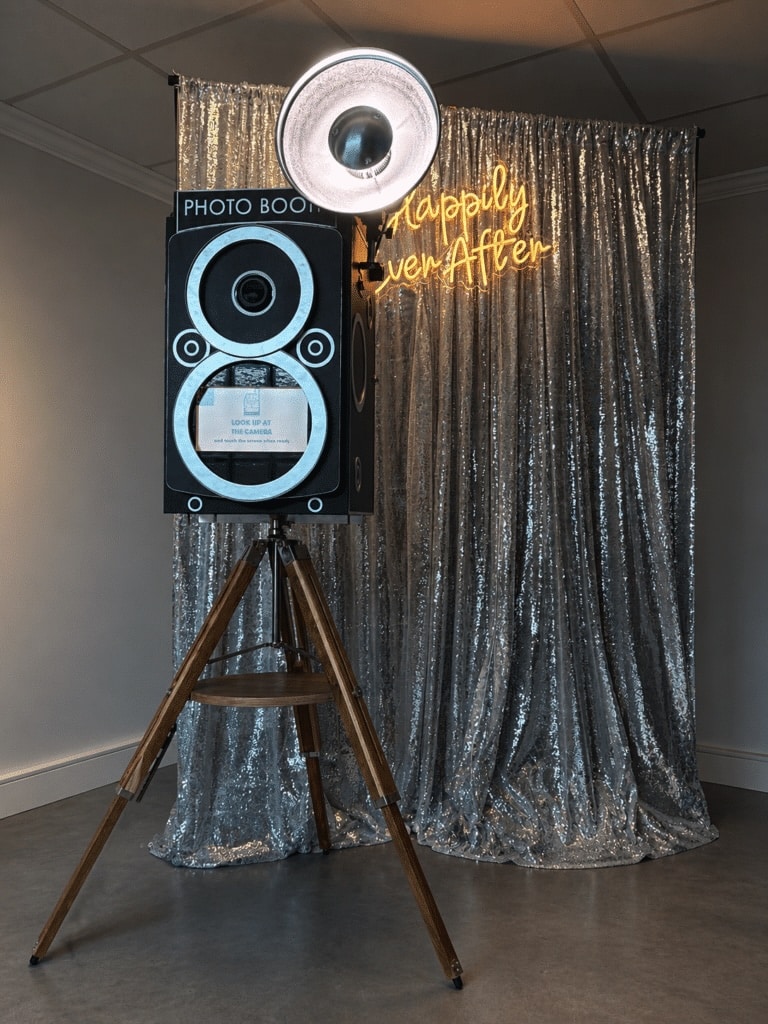 Vintage photo booth setup for weddings and events with silver sequin backdrop