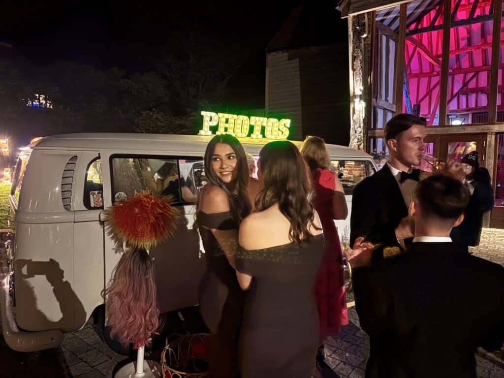 Wedding guests using photo booth at Kent reception