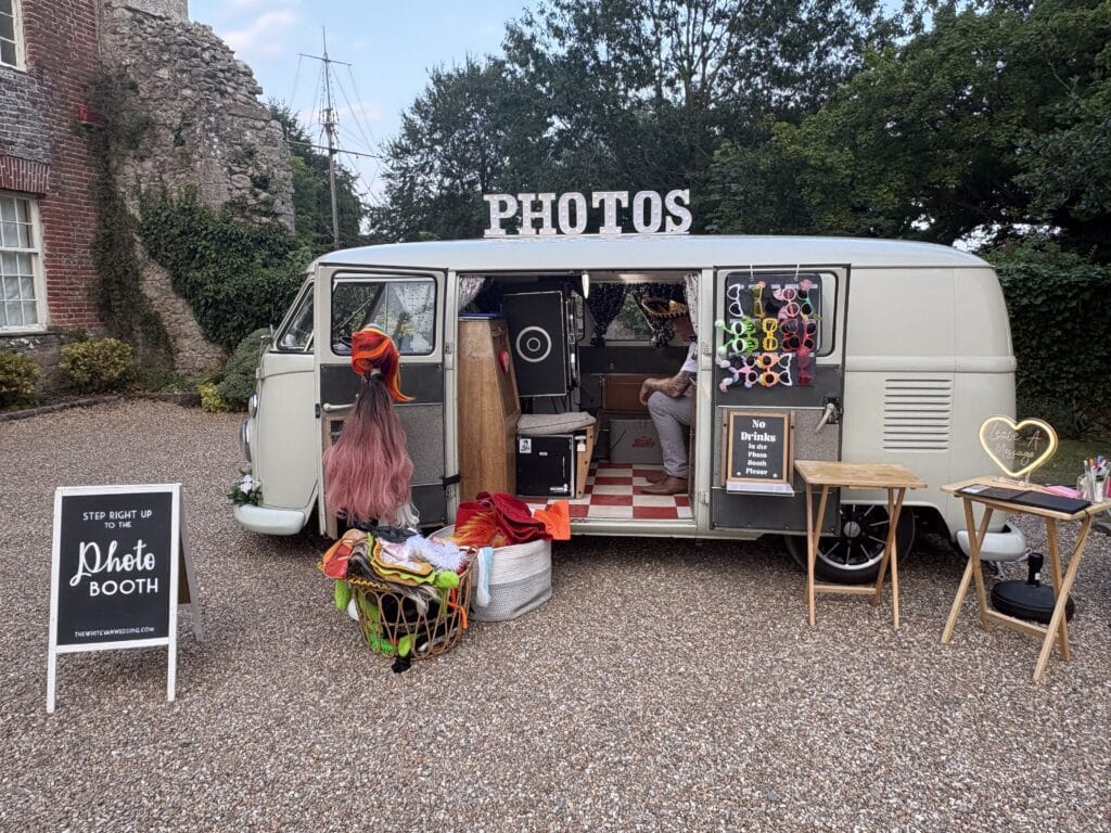 VW camper photo booth set up with props for a wedding