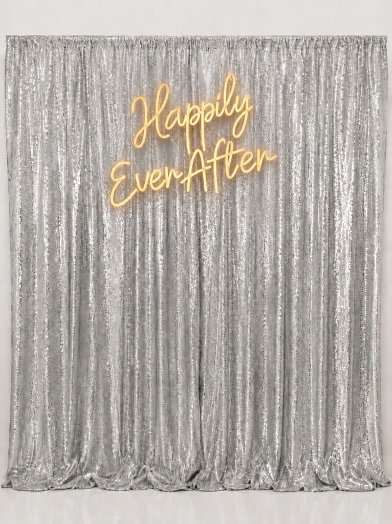 silver backdrop with neon sign